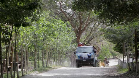 A-van-drives-down-a-rural-road-in-Guatemala
