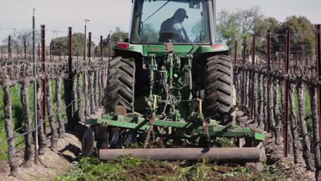 A-tractor-mows-a-cover-crop-between-rows-of-grapes-on-a-California-vineyard-1