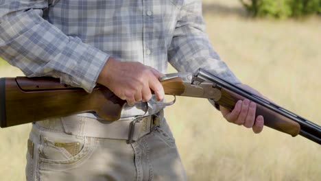 A-slow-motion-clip-of-a-sport-shooter-ejecting-shells-from-a-double-barrel-shotgun