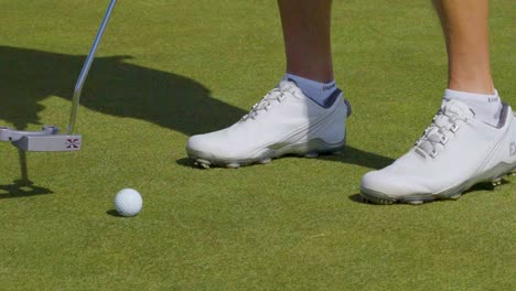 Close-up-shot-of-a-golfer-practicing-his-putting-putting-technique-on-a-golf-green