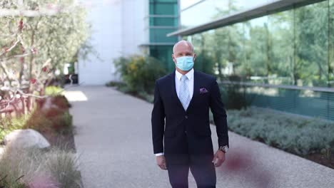 A-model-released-man-demonstrates-the-proper-way-to-put-on-a-protective-mask-during-the-Covid19-coronavirus-epidemic-outbreak