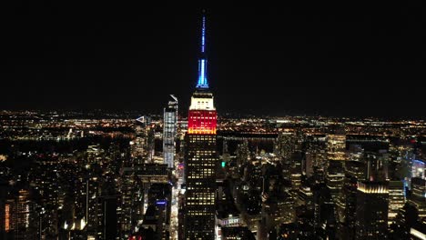 Good-aerial-of-the-spire-of-the-Empire-State-Building-lit-up-red-white-and-blue-in-New-York-City-New-York