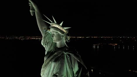 An-excellent-orbiting-aerial-view-shows-the-upper-half-of-the-Statue-of-Liberty-in-New-York-City-New-York-at-night