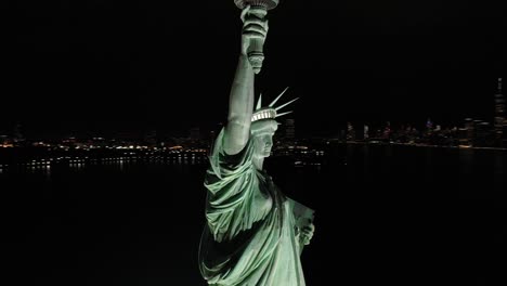 An-excellent-orbiting-aerial-view-shows-the-upper-half-of-the-Statue-of-Liberty-in-New-York-City-New-York-at-night-1