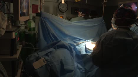 A-Surgery-Is-Performed-In-A-Darkened-Operating-Room