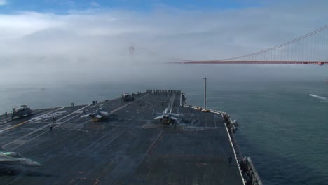 An-Aircraft-Carrier-Sails-Under-The-Golden-Gate-Bridge