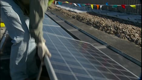 A-Crew-Installs-Solar-Panels-On-The-Roof-Of-A-Local-Business