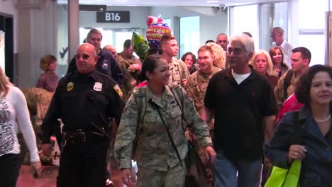 Us-Servicemen-And-Women-Are-Welcomed-Home-In-An-Airport-After-A-Recent-Deployment-To-Afghanistan-2