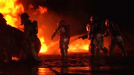 Firemen-In-Hazmat-Or-Heat-Resistant-Suits-Fight-An-Intense-Fire-At-Night-2