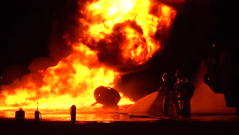 Firemen-In-Hazmat-Or-Heat-Resistant-Suits-Fight-An-Intense-Fire-At-Night-3
