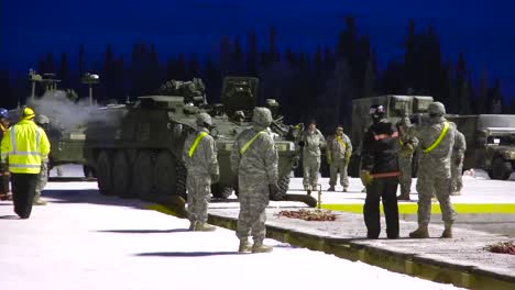 Tanks-Are-Loaded-Onto-A-Train-By-Us-Military-Personnel-In-The-Snow