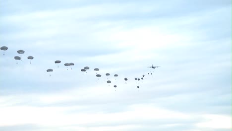 Various-Ground-Views-Of-Paratroopers-Jumping-From-Military-Aircraft
