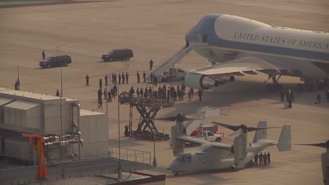 An-Entourage-Awaits-The-President-Of-The-United-States-As-He-Emerges-From-Air-Force-One
