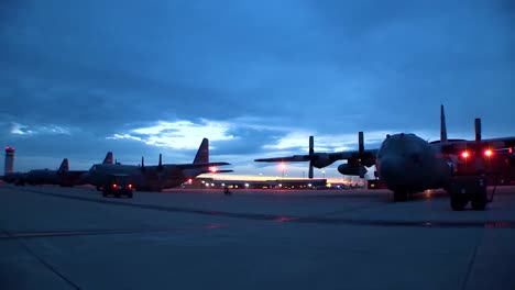 A-Fleet-Of-C130-Herculese-Sit-On-The-Flightline-During-Sunrise-In-This-Timelapse-Shot