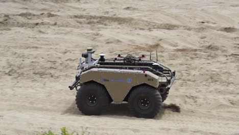 A-Remote-Controlled-Tank-Carries-A-Small-Drone-On-Its-Back-In-A-Military-Maneuver