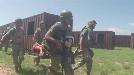 As-Part-Of-A-Training-Exercise-At-Cannon-Afb-Airmen-Must-Carry-A-Wounded-Comrade-Through-A-Gas-Attack