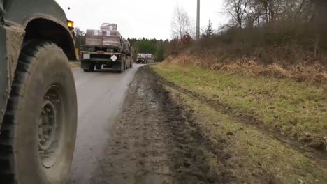 A-Us-Army-Convoy-Of-Soliders-And-Supplies-Moves-Along-A-Muddy-Road-In-Germany