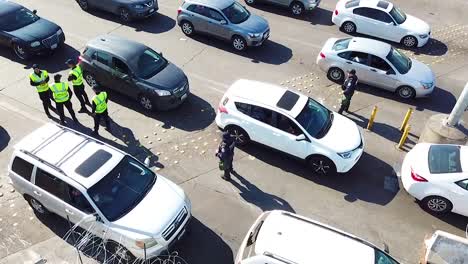 Border-Patrol-Agents-Wait-To-Inspect-A-Line-Of-Cars-At-The-San-Ysidro-Tijuana-Us-Mexico-Border-Crossing