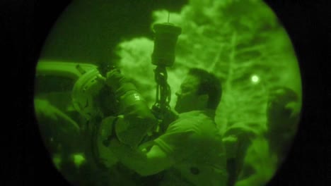 A-Military-Search-And-Rescue-Commando-Rescues-A-Civilian-Man-From-An-Emergency-Via-Rope-And-Helicopter-In-Night-Vision