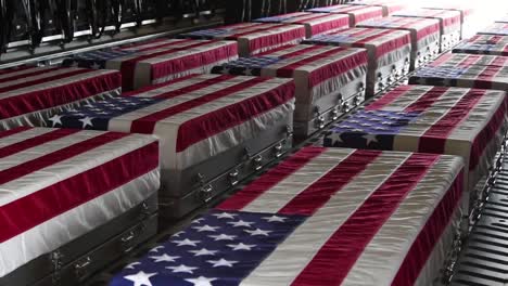 Pan-Across-Flag-Draped-Coffins-Of-Dead-Us-Soldiers-Being-Returned-Home-In-A-C130-Cargo-Plane