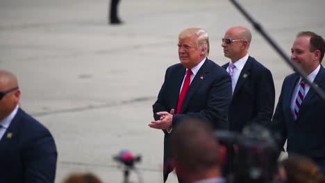 The-President-Of-The-United-States-Donald-J-Trump-Walks-On-A-Tarmac-And-Greets-Admiring-Army-Military-Personnel-At-A-Rally-Gets-Into-Limousine