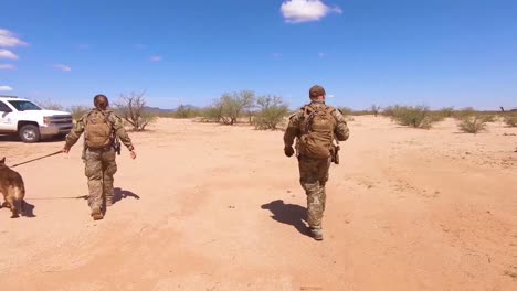 Members-Of-The-Us-Border-Patrol-Walk-With-A-K9-Canine-Dog-To-A-Waiting-Border-Patrol-Vehicle