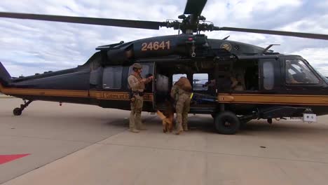 Members-Of-The-Us-Border-Patrol-Walk-With-A-K9-Canine-Dog-To-A-Waiting-Helicopter