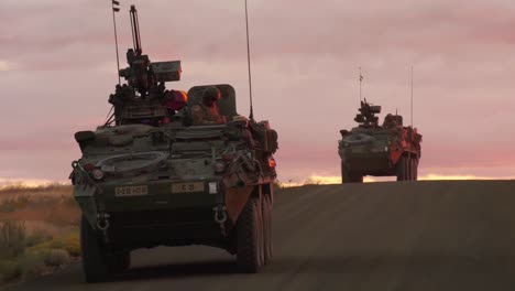 Ein-Konvoi-Von-Uns-Militärfahrzeugen-Fährt-Bei-Sonnenuntergang-Oder-Sonnenaufgang-In-Einem-Fremden-Land