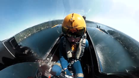 A-Us-Navy-Blue-Angel-Pilot-Is-Seen-In-His-Aircraft-Flying-Over-Seattle-As-He-Rolls-Upsidedown-In-An-Air-Show