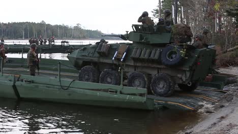 Us-Marines-Drive-Amphibious-Vehicles-Onto-Barges-During-A-Training-Exercise