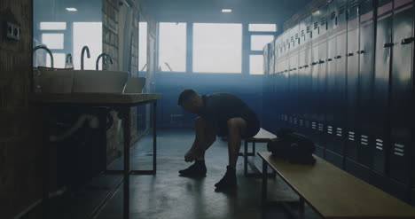 Man-Tying-Shoes-in-Locker-Room