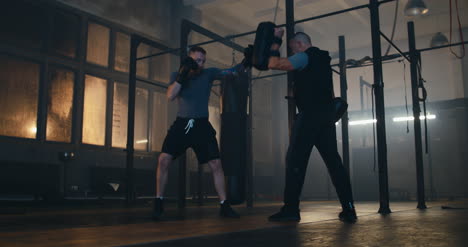 Man-Boxing-with-Trainer