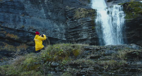 Man-Photographing-Waterfall