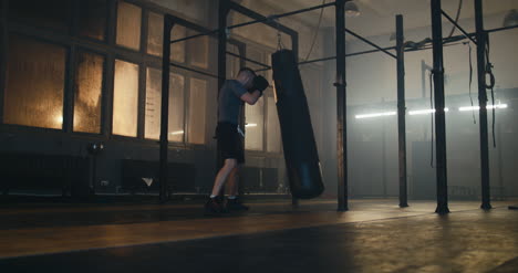 Man-Punching-Bag-in-Boxing-Gym