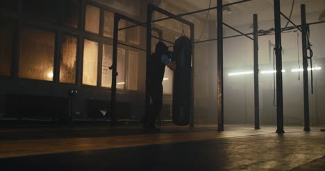 Man-Punching-Bag-in-Gym