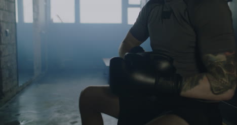 Man-Putting-on-Boxing-Gloves