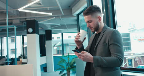 Man-in-Suit-on-Phone-and-Coffee