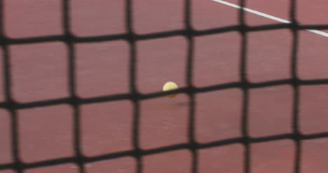 Tennis-Ball-Rolling-Across-Court-01