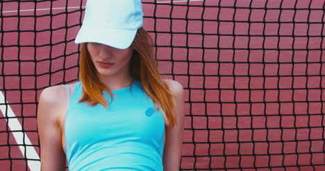 Tennis-Girl-Leaning-on-Net