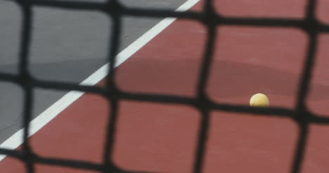 Tennis-Ball-Rolling-Across-Court-02