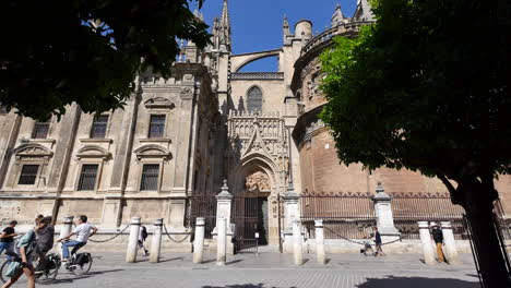Seville-Cathedral-With-Bicycles-Going-By