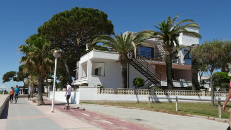 Spain-Cambrils-Skateboarder-And-Monocycle-By-Apartments