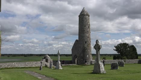 Ireland-Clonmacnoise-A-Round-Tower-Stands-Amid-Celtic-Crosses-By-The-Shannon-River