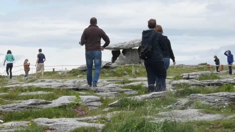 Ireland-County-Clare-Tourists-Walk-Towards-A-Dolmen-Zoom-And-Pan-