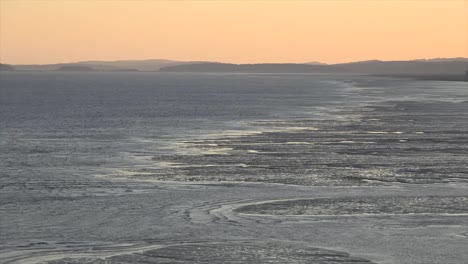 Canada-New-Brunswick-Incoming-Tide-Under-Orange-Sky