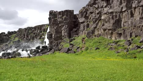 Iceland-Pingvellir-Man-Standing-By-Waterfall