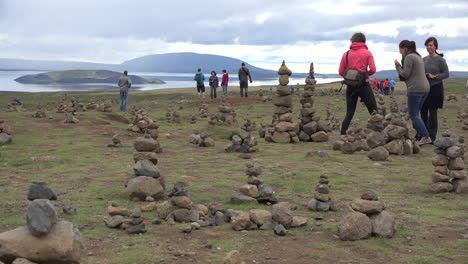 Iceland-Landscape-With-Cairns-And-Woman-In-Orange