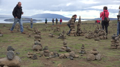 Iceland-Landscape-With-Cairns-And-Woman-Taking-A-Picture