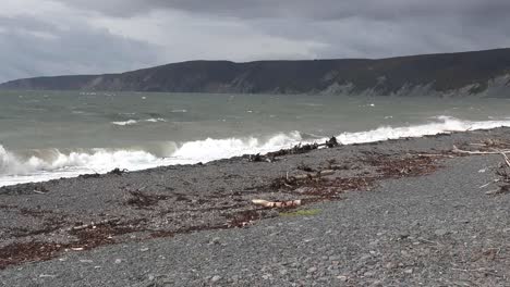 Canada-Bay-Of-Fundy-Pebble-Beach-Under-Cloudy-Sky-Pan