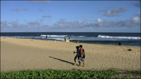 Oahu-Sandy-Beach-Couple-Walks-On-Sand